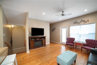 Living room featuring a glass covered fireplace, l