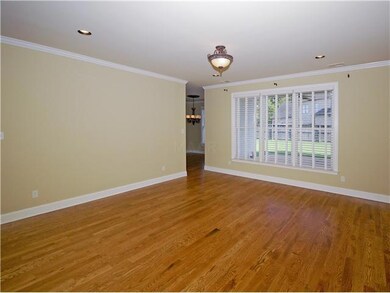 Charming living room with smooth ceiling and hardw