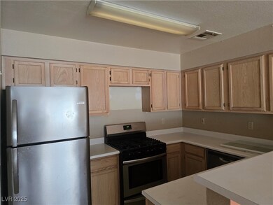 Kitchen with stainless steel appliances, light bro