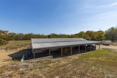 View of pole building with a view of countryside and view of scattered trees