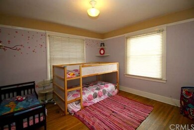 Front bedroom with original hardwood floors.