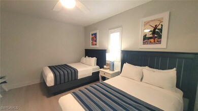 Bedroom with ceiling fan and wood finished floors