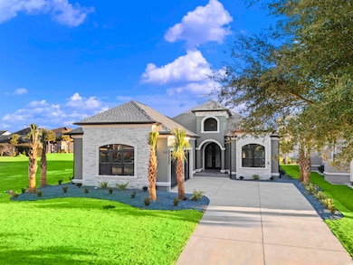 Mediterranean / spanish home featuring a front law