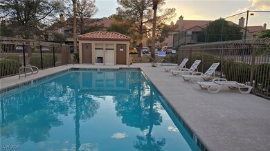 Community pool with fence and a patio