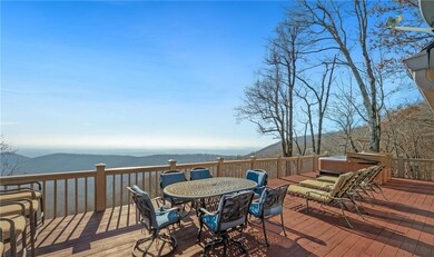Wooden terrace with a mountain view, a hot tub, an