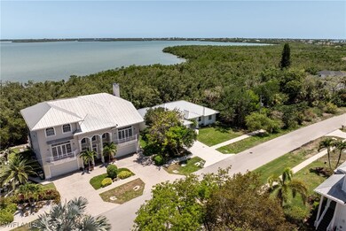 View of subject property featuring a large body of water and a heavily wooded area