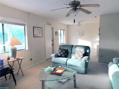 Carpeted living room featuring baseboards