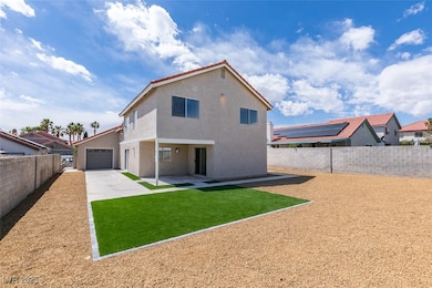 Back of property with a fenced backyard, driveway,