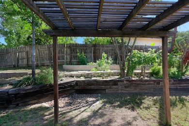 Fenced backyard with a pergola