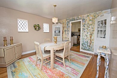 Charming dining room features hard wood floor, cor