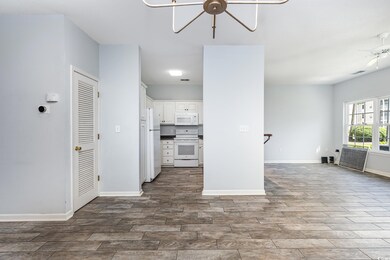 Kitchen featuring white appliances, white cabinetr