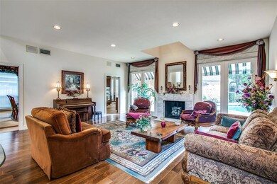 Large versatile living room looks out to the backyard pool and is shaded by custom awnings.