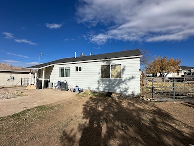 Back of property featuring a gate and a patio