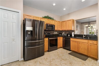 Kitchen with black stainless appliances and granit
