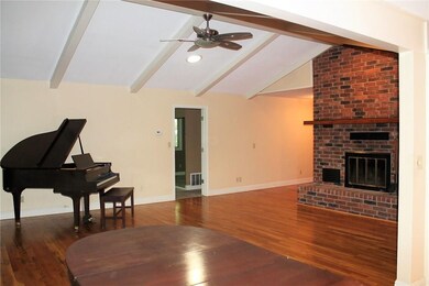 Living room, lots of light and windows, wood burning fire place, master in left doorway, masters up, other two bedrooms down.