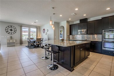 Elegant espresso wood cabinets with large granite 