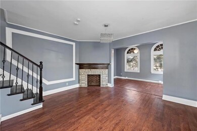 Charming living space with rich hardwood floors, c