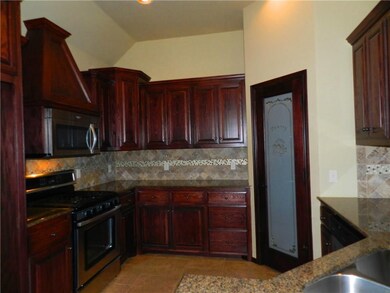 Kitchen with gas stove and pantry.