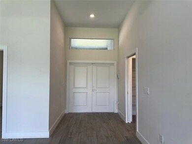 Corridor featuring baseboards, dark wood finished