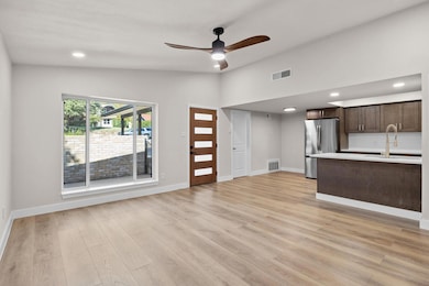 Unfurnished living room featuring recessed lighting, vaulted ceiling, light wood-style floors, and ceiling fan
