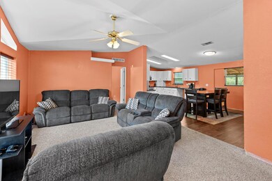 Living room with vaulted ceiling, dark colored ca