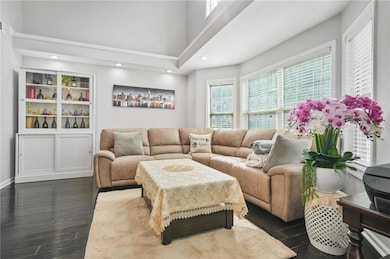 Living area with dark wood finished floors, recess