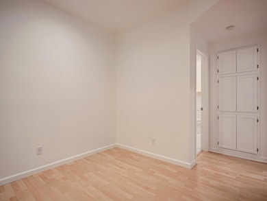 Spare room with light wood-type flooring, baseboa