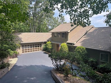 A closer look at widened driveway, parking pad - and freshly painted garage door.