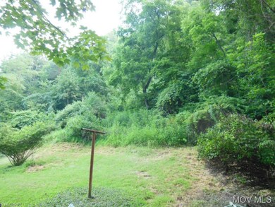 Hilly and wooded behind the house