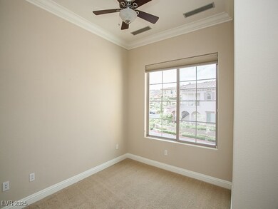 Spare room featuring ornamental molding, light car