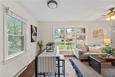 Living room featuring a baseboard heating unit, ha