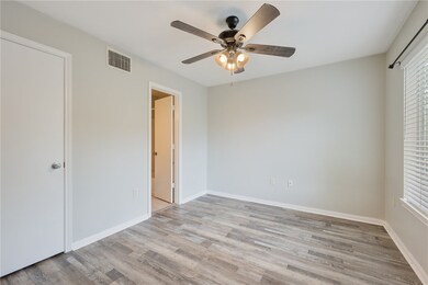 Unfurnished bedroom with baseboards, light wood-st