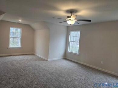 Additional living space with light carpet, lofted ceiling, and ceiling fan