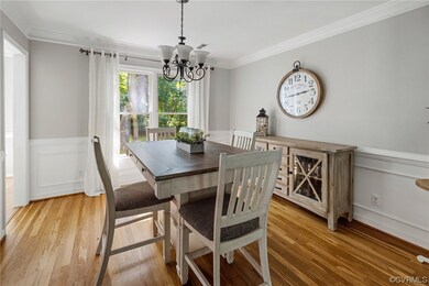 Wood floored dining space with a chandelier and or