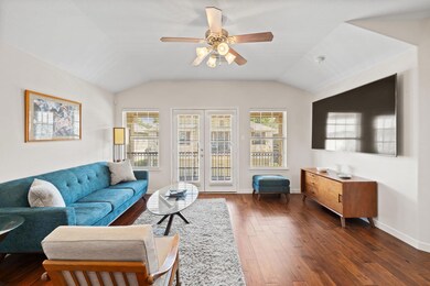 Living area featuring ceiling fan, plenty of natu