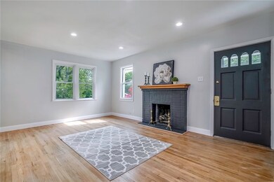 Spacious living space with decorative fireplace, n