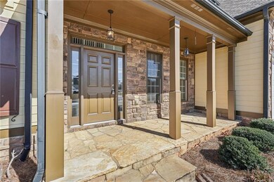 View of exterior entry featuring stone siding and 