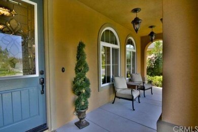 Cute front porch with leaded glass front door. 