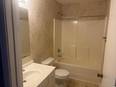 Bathroom featuring vanity and  shower combination