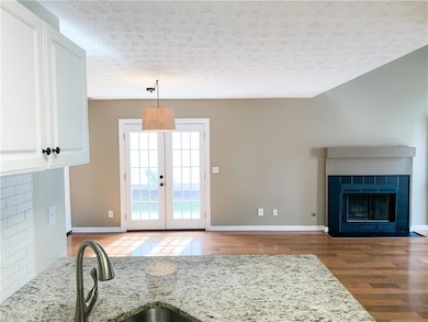 View from kitchen to dining and fireplace