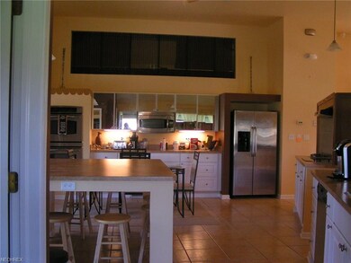 White cabinetry and GE stainless appliances compli