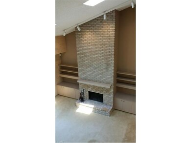 The floor to ceiling fireplace with built-in shelv