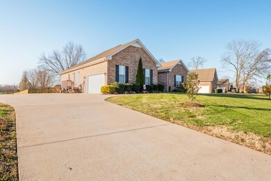 This all brick home is located in the Harris Farms subdivision.