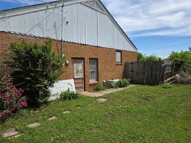 View of side of property with a lawn, brick siding