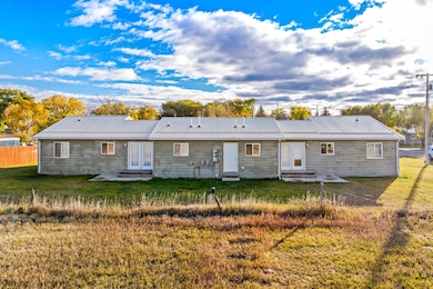 Back of property with a patio area, a metal roof, and entry steps