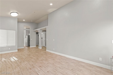 Unfurnished living room with ornate columns, light