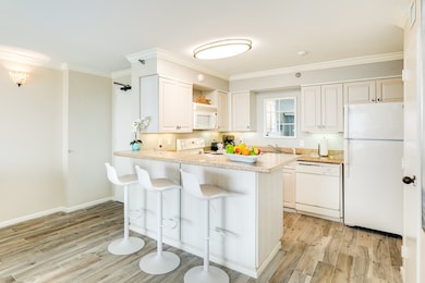 Kitchen with a breakfast bar and open to the livin