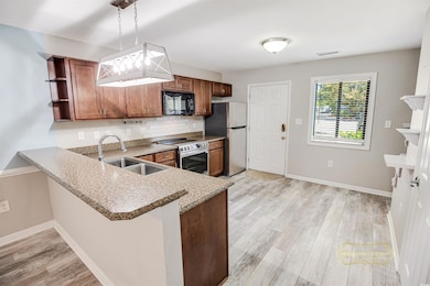 Kitchen featuring light wood-type flooring, open s
