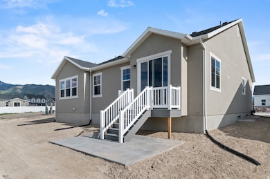 Rear view of property with stucco siding and a mountain view