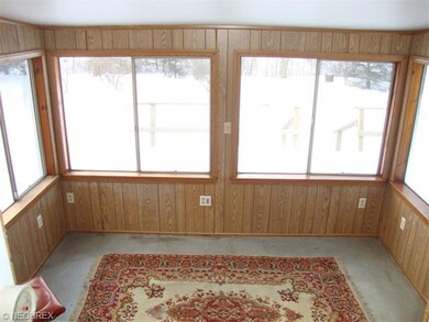 Sunroom that opens up to a large deck area.